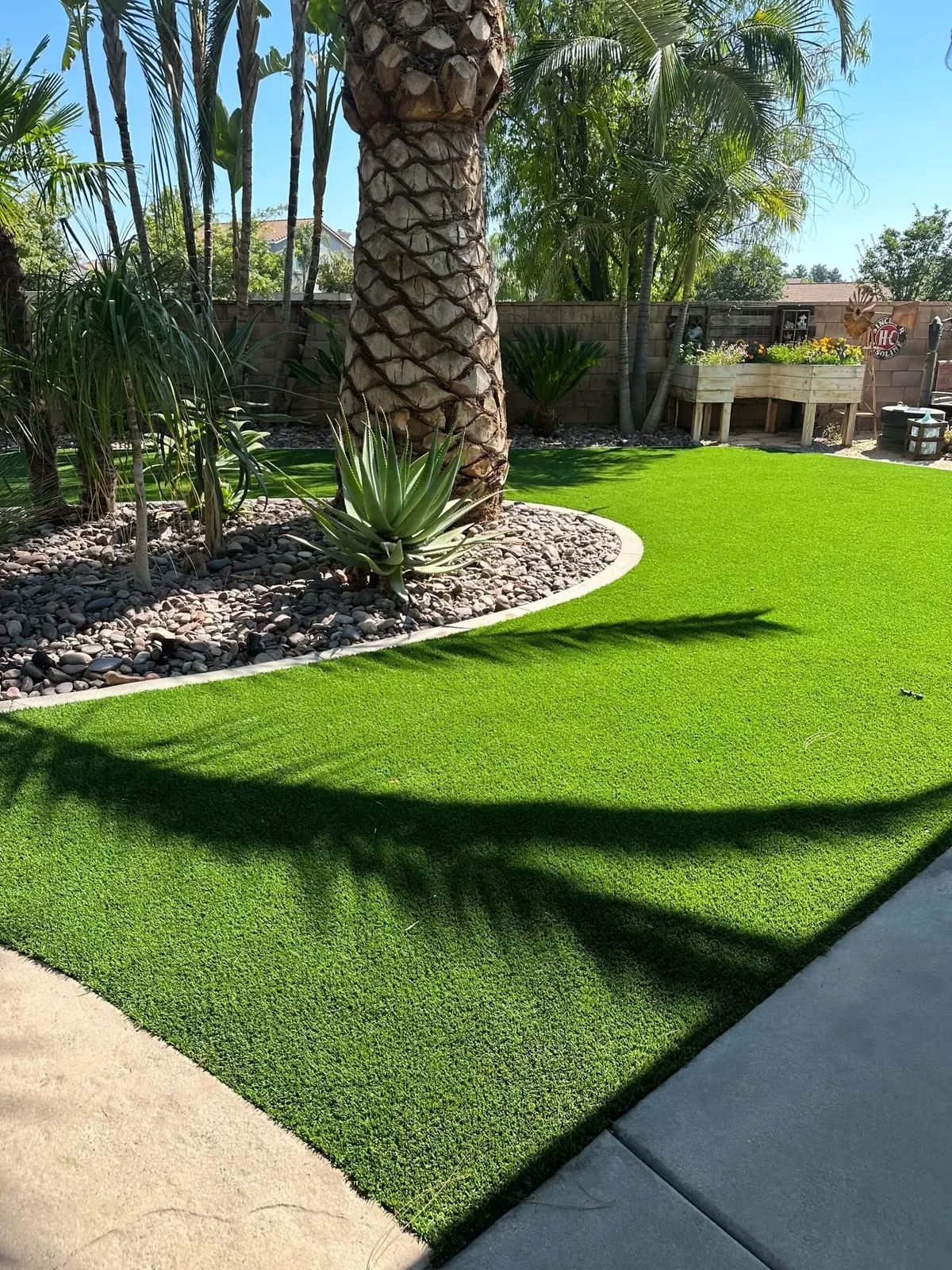 Lush artificial grass lawn surrounding outdoor living space